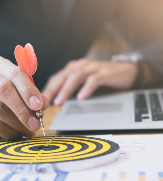Businessman holding red dart push on target. Business strategy planning success target goals. Business development concept