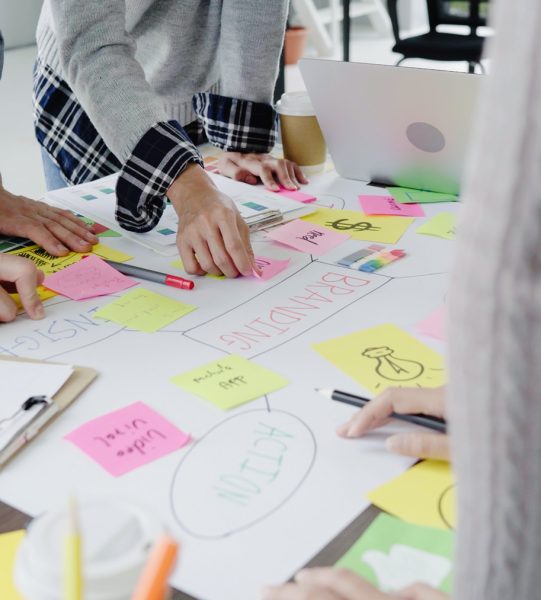 Group of casually dressed business people discussing ideas in the office. Creative professionals gathered at the meeting table for discuss the important issues of the new successful startup project.